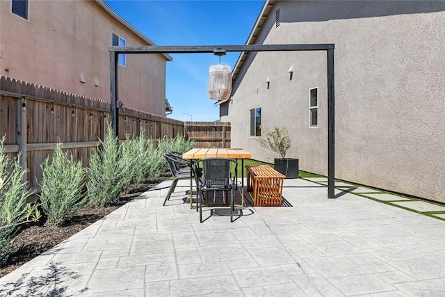 1628 N Delbert Ave, Fresno, CA 93722 - view of patio featuring outdoor dining area and a fenced backyard