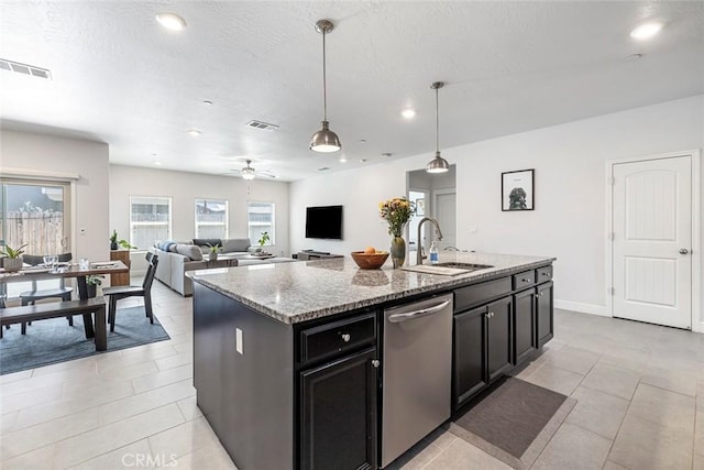 1628 N Delbert Ave, Fresno, CA 93722 - kitchen with visible vents, stainless steel dishwasher, a sink, decorative light fixtures, and light stone countertops