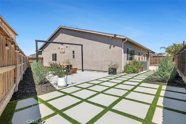 1628 N Delbert Ave, Fresno, CA 93722 - back of house with a patio, a fenced backyard, and stucco siding