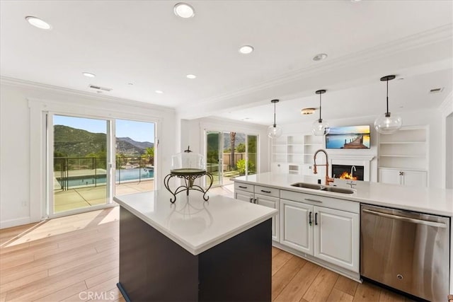 2836 Mesa Grove Rd, Fallbrook, CA 92028 - kitchen with dishwasher, a sink, crown molding, a lit fireplace, and a center island with sink