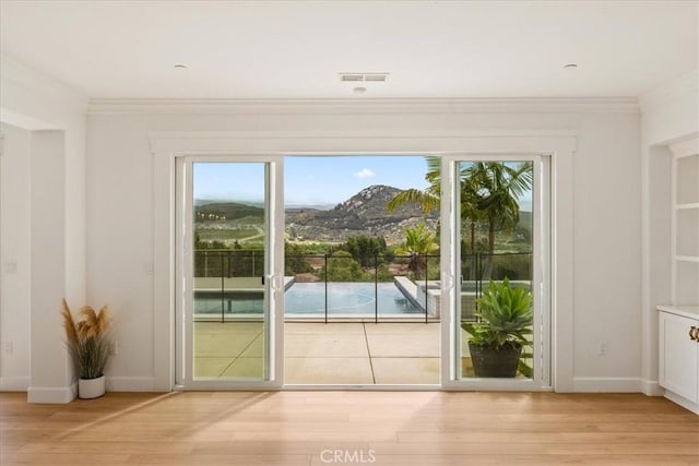 2836 Mesa Grove Rd, Fallbrook, CA 92028 - entryway with ornamental molding, light wood-type flooring, healthy amount of natural light, and baseboards