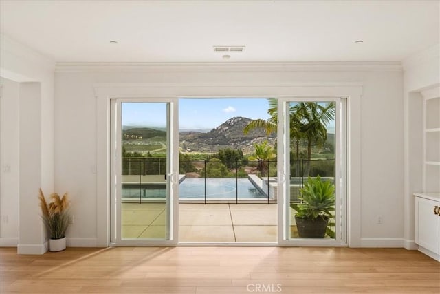 2836 Mesa Grove Rd, Fallbrook, CA 92028 - doorway to outside featuring ornamental molding, light wood-style flooring, and healthy amount of natural light