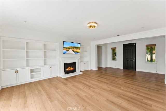 2836 Mesa Grove Rd, Fallbrook, CA 92028 - unfurnished living room with crown molding, light wood finished floors, a glass covered fireplace, built in features, and baseboards