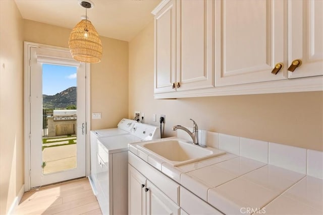 2836 Mesa Grove Rd, Fallbrook, CA 92028 - laundry area featuring cabinet space, separate washer and dryer, light wood-type flooring, and a mountain view
