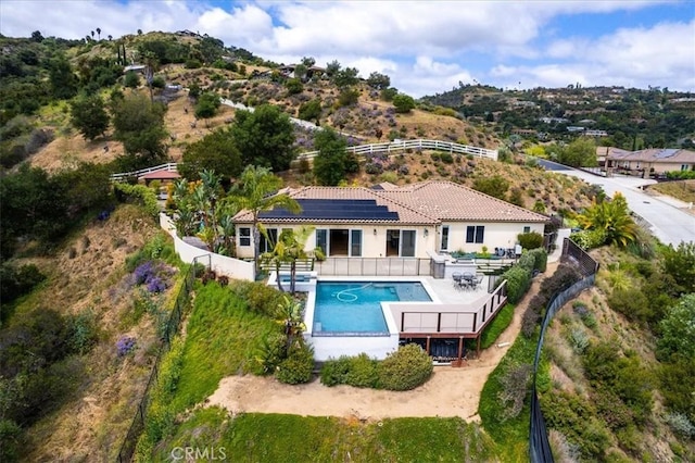 2836 Mesa Grove Rd, Fallbrook, CA 92028 - back of property with a fenced backyard, solar panels, and stucco siding