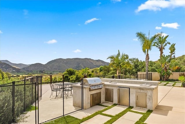 2836 Mesa Grove Rd, Fallbrook, CA 92028 - view of patio with grilling area, an outdoor kitchen, a mountain view, and fence