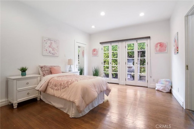 bedroom featuring baseboards, recessed lighting, wood finished floors, and access to exterior