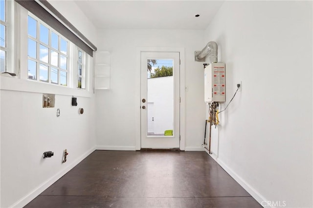 laundry room with tankless water heater and baseboards