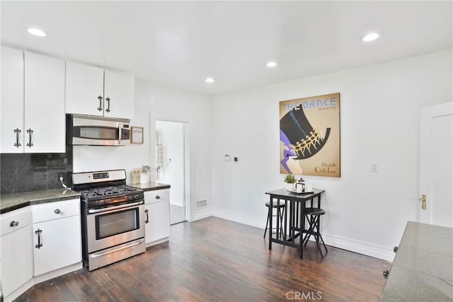 kitchen featuring stainless steel appliances, dark wood-style floors, recessed lighting, white cabinetry, and decorative backsplash