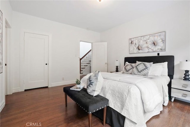 bedroom featuring baseboards and wood finished floors