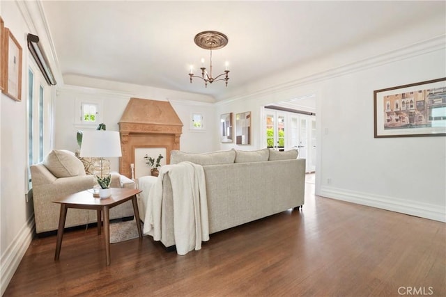 living area with plenty of natural light, baseboards, a notable chandelier, and dark wood-style floors