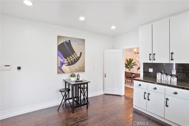 kitchen with white cabinetry, backsplash, baseboards, dark wood-style flooring, and recessed lighting