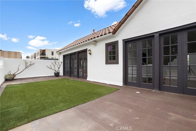 view of yard with a fenced backyard, a patio area, and french doors