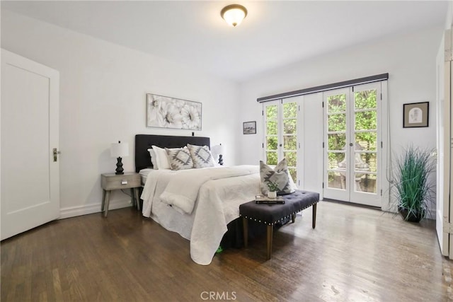 bedroom featuring wood finished floors, baseboards, access to outside, and french doors