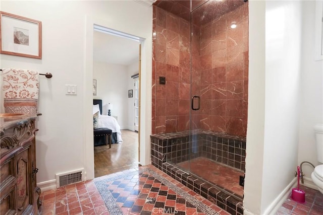 bathroom with baseboards, visible vents, toilet, and a stall shower