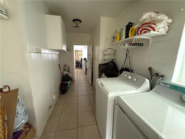 laundry room featuring light tile patterned flooring, visible vents, independent washer and dryer, and laundry area
