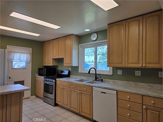 1370 S Oriole St, Anaheim, CA 92804 - kitchen featuring white dishwasher, gas range, black microwave, light tile patterned floors, and healthy amount of natural light