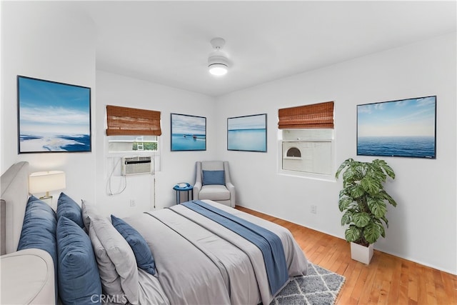 bedroom featuring cooling unit and wood finished floors