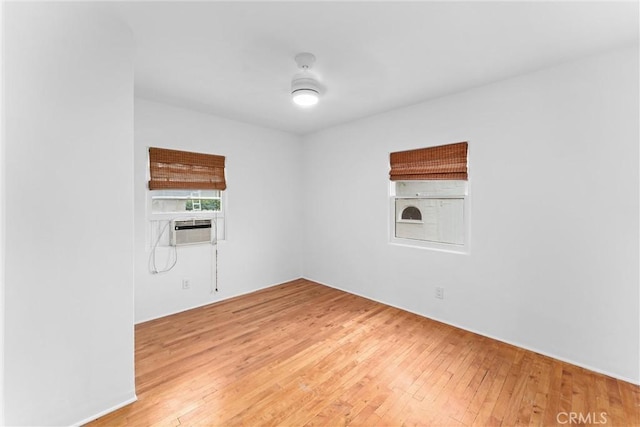 spare room featuring wood-type flooring and cooling unit
