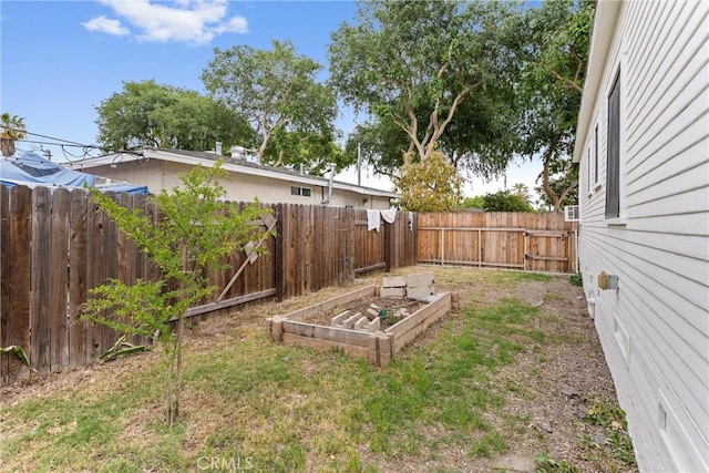 view of yard featuring a vegetable garden and a fenced backyard