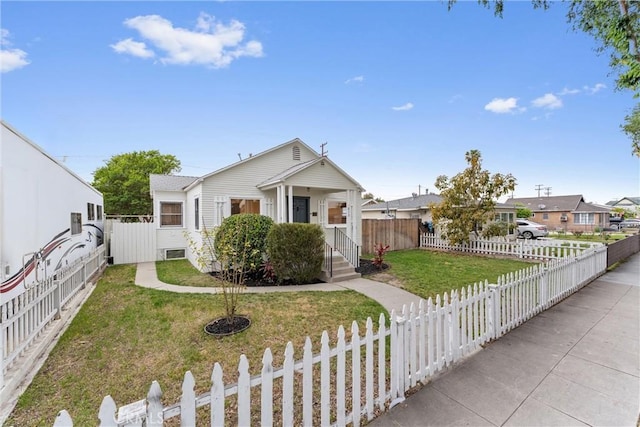 bungalow featuring fence private yard and a front yard