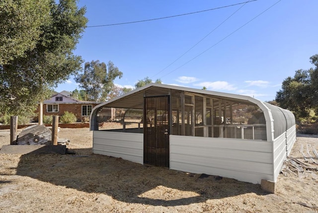 back of property with a sunroom