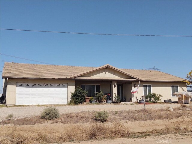 9373 Nevada Rd, Phelan, CA 92371 - single story home featuring an attached garage, driveway, covered porch, and stucco siding