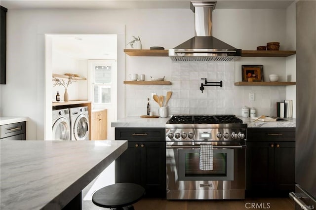 3702 Seneca Ave, Los Angeles, CA 90039 - kitchen with open shelves, decorative backsplash, washer and dryer, wall chimney exhaust hood, and stainless steel gas range oven
