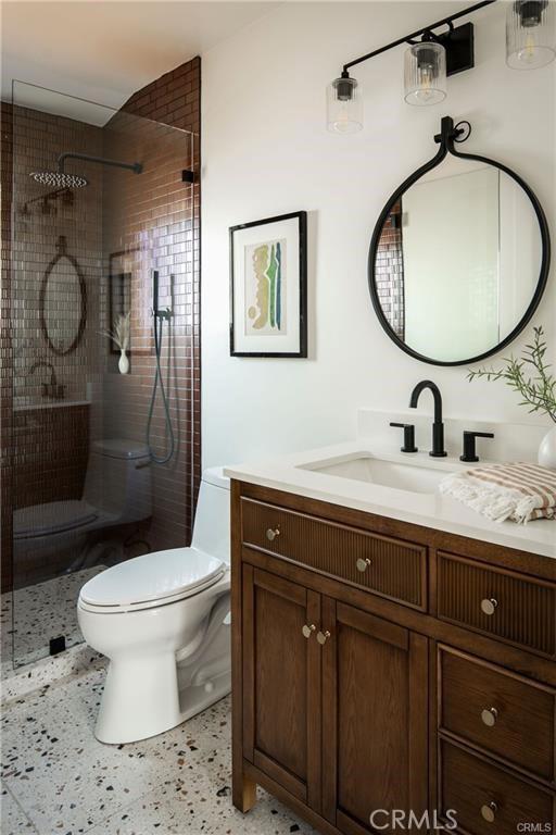 3702 Seneca Ave, Los Angeles, CA 90039 - full bathroom featuring tiled shower, vanity, speckled floor, and toilet