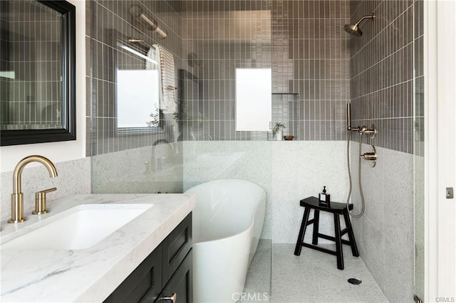 3702 Seneca Ave, Los Angeles, CA 90039 - full bath with a freestanding bath, tiled shower, tile walls, speckled floor, and vanity