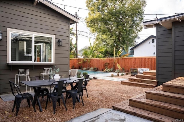 3702 Seneca Ave, Los Angeles, CA 90039 - view of patio with a wooden deck, a fenced in pool, outdoor dining area, and a fenced backyard