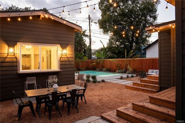 3702 Seneca Ave, Los Angeles, CA 90039 - exterior space featuring a wooden deck, outdoor dining space, a fenced in pool, and a fenced backyard