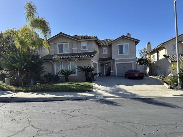 view of front of home featuring concrete driveway, a chimney, a tiled roof, an attached garage, and stucco siding