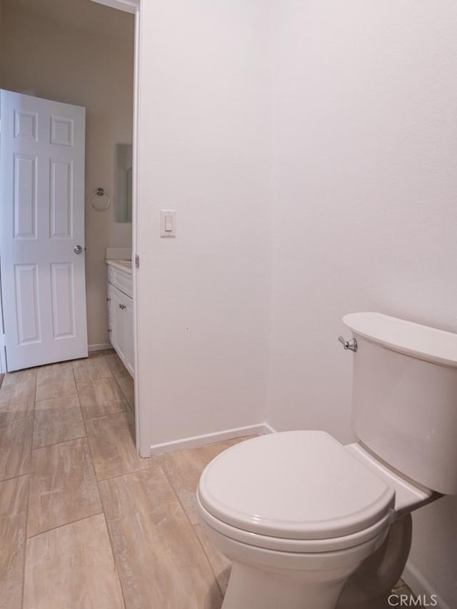 1334 Pinehurst Dr, Calimesa, CA 92320 - bathroom featuring baseboards, wood finished floors, toilet, and vanity