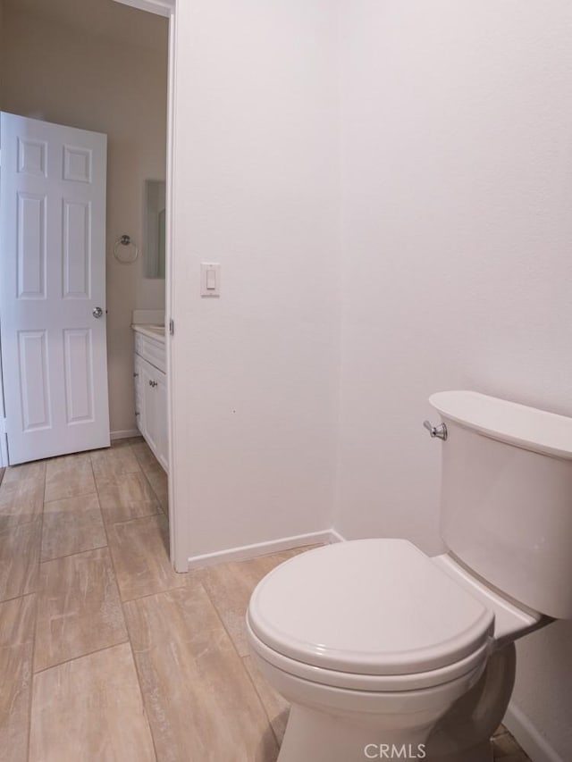 1334 Pinehurst Dr, Calimesa, CA 92320 - half bath with toilet, vanity, baseboards, and wood finished floors