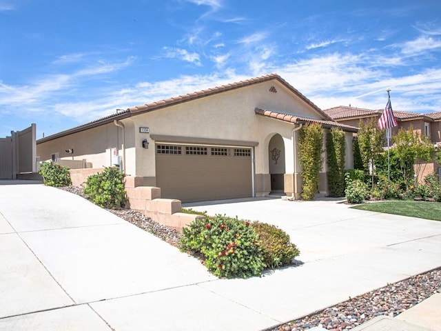 1334 Pinehurst Dr, Calimesa, CA 92320 - view of front of house featuring stucco siding, driveway, a tiled roof, and a garage