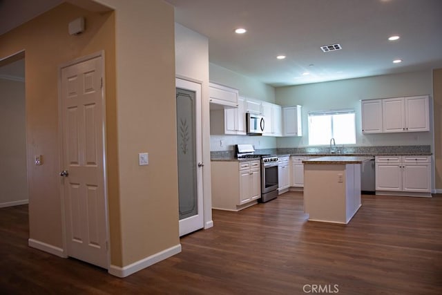 1334 Pinehurst Dr, Calimesa, CA 92320 - kitchen with a center island, visible vents, appliances with stainless steel finishes, and baseboards