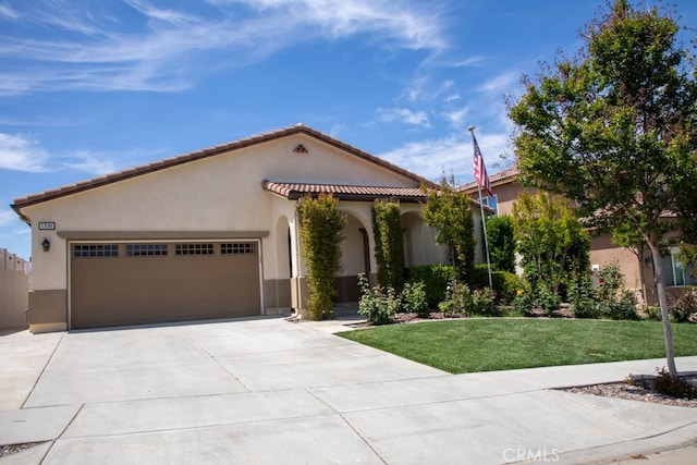 1334 Pinehurst Dr, Calimesa, CA 92320 - mediterranean / spanish house with concrete driveway, a tiled roof, a front yard, an attached garage, and stucco siding