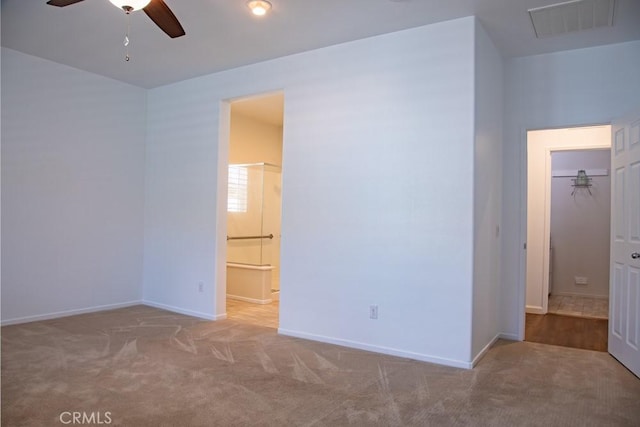 1334 Pinehurst Dr, Calimesa, CA 92320 - unfurnished bedroom featuring visible vents, connected bathroom, carpet flooring, and baseboards