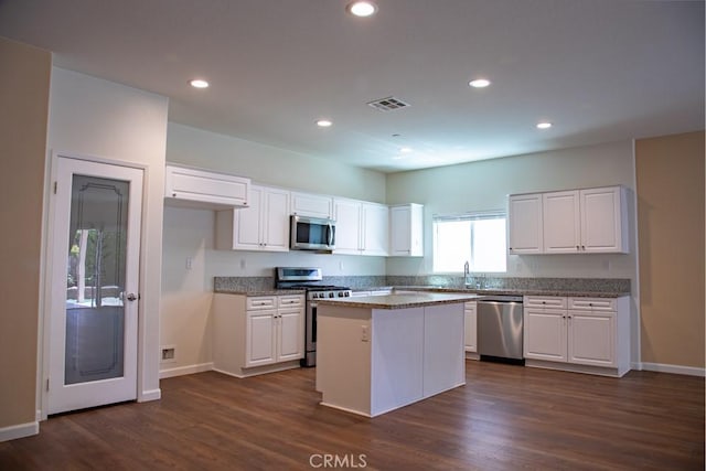 1334 Pinehurst Dr, Calimesa, CA 92320 - kitchen with white cabinetry, stainless steel appliances, dark wood-style floors, and baseboards