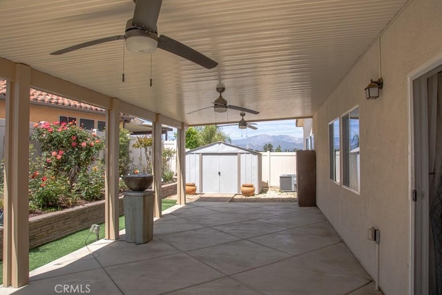 1334 Pinehurst Dr, Calimesa, CA 92320 - view of patio featuring a storage shed, ceiling fan, a mountain view, fence, and central AC