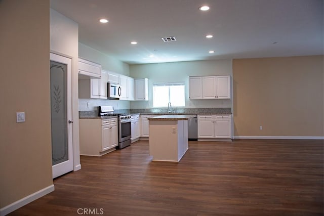 1334 Pinehurst Dr, Calimesa, CA 92320 - kitchen with recessed lighting, dark wood-style flooring, visible vents, white cabinetry, and appliances with stainless steel finishes