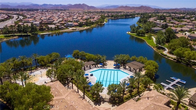 drone / aerial view with a residential view and a water and mountain view