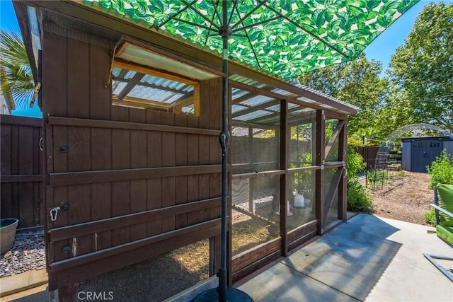 view of shed featuring fence