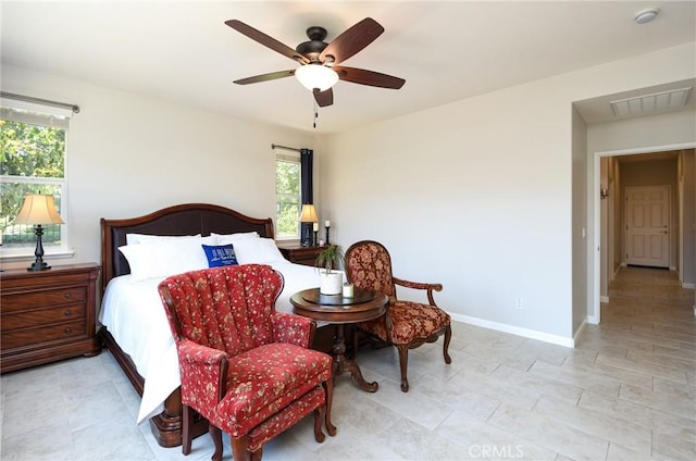 bedroom featuring baseboards, ceiling fan, and visible vents