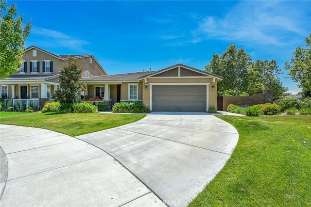view of front facade featuring covered porch, a front lawn, concrete driveway, an attached garage, and stucco siding