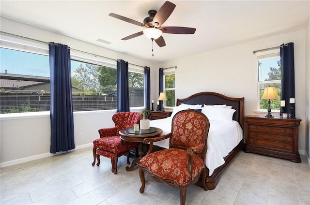 bedroom featuring light tile patterned floors, baseboards, a ceiling fan, and visible vents