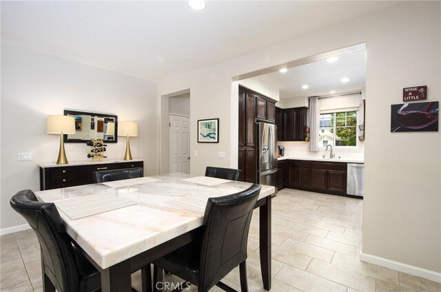dining area with recessed lighting, baseboards, and light tile patterned flooring