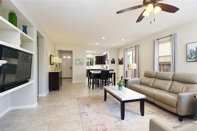 living area featuring a healthy amount of sunlight, ceiling fan, recessed lighting, and light tile patterned flooring