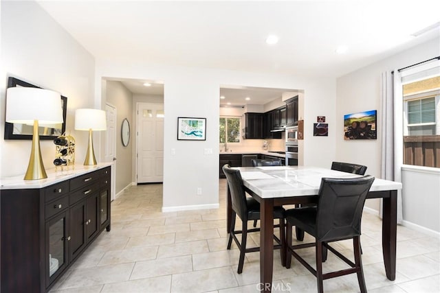 dining area featuring recessed lighting, baseboards, and light tile patterned flooring